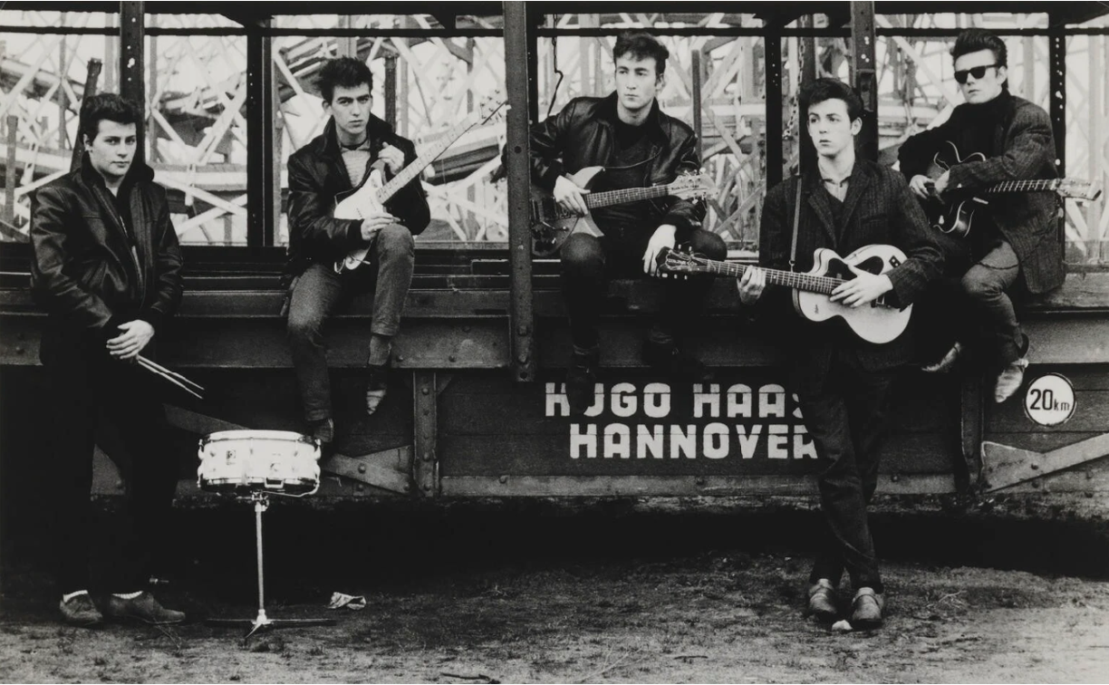 An early photo of the Beatles, including Pete Best & Stu Sutcliffe. Original source: National Portrait Gallery, https://www.npg.org.uk/collections/search/portrait/mw216098/The-Beatles-Pete-Best-George-Harrison-John-Lennon-Paul-McCartney-Stuart-Sutcliffe.